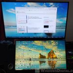 How do I display different things on two monitors Windows 11